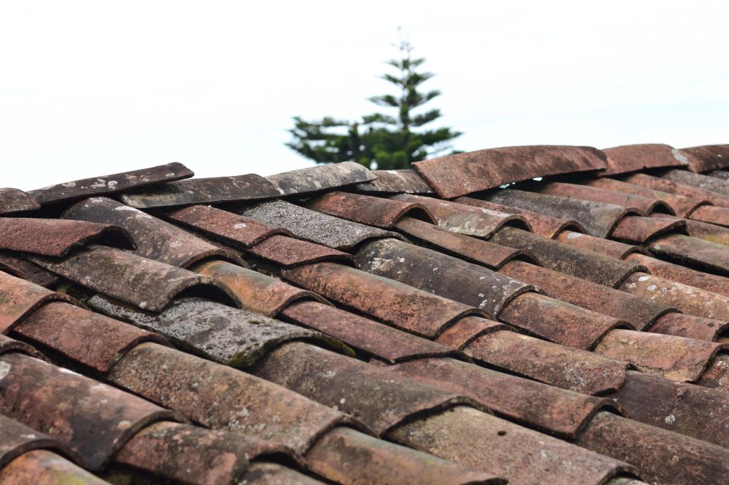 An image of a roof with tiles that are out of place and need repairing.