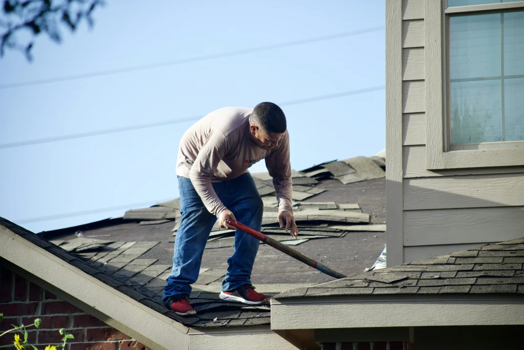 a man re-doing his roof tiles